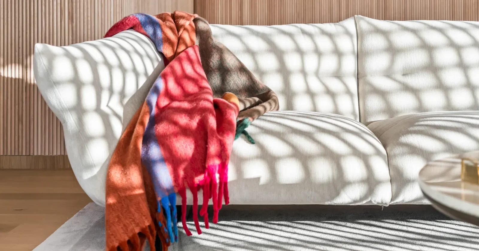 Casa Lamar showroom — sofa with a colorful throw